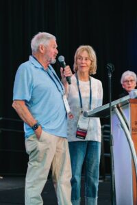 Bob talking at award presentation with Mary looking on